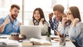 Surprised students getting exam results on laptop Royalty Free Stock Photo