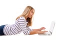 Surprised teen girl laying on the floor using laptop isolated Royalty Free Stock Photo