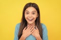 surprised teen girl with long hair on yellow background, surprise Royalty Free Stock Photo