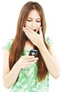 Surprised teen girl looking at the mobile phone Royalty Free Stock Photo