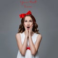 Surprised teen girl with red bow on head Royalty Free Stock Photo