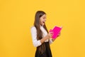 surprised teen girl in school uniform reading book, book lover Royalty Free Stock Photo