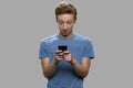 Surprised teenage boy using mobile phone. Royalty Free Stock Photo