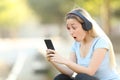 Surprised teenage girl finding music offers on phone