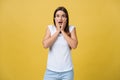 Surprised teenage girl show shocking expression with something. Isolated on Bright Yellow Background. Copy space Royalty Free Stock Photo