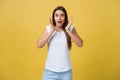 Surprised teenage girl show shocking expression with something. Isolated on Bright Yellow Background. Copy space Royalty Free Stock Photo