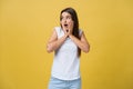 Surprised teenage girl show shocking expression with something. Isolated on Bright Yellow Background. Copy space Royalty Free Stock Photo