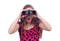 Surprised teenage girl watching with binoculars