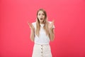 Surprised teenage student girl show shocking expression with something. on Bright Pink Background. Copy space Royalty Free Stock Photo