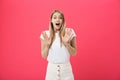 Surprised teenage student girl show shocking expression with something. on Bright Pink Background. Copy space Royalty Free Stock Photo