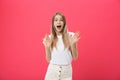 Surprised teenage student girl show shocking expression with something. on Bright Pink Background. Copy space Royalty Free Stock Photo