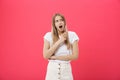 Surprised teenage student girl show shocking expression with something. Isolated on Bright Pink Background. Copy space Royalty Free Stock Photo