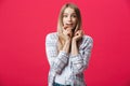 Surprised teenage student girl show shocking expression with something. Isolated on Bright Pink Background. Copy space Royalty Free Stock Photo