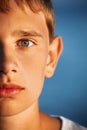 Surprised teenager boy against sea, half of face Royalty Free Stock Photo