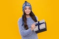 Surprised teenager girl. Funny kid girl in winter wear holding gift boxes celebrating happy New Year or Christmas Royalty Free Stock Photo