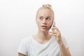 Surprised upset young blonde woman with her smart phone Royalty Free Stock Photo