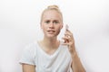 Surprised upset young blonde woman with her smart phone Royalty Free Stock Photo