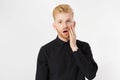 Surprised white man, opened his mouth , his hand on face, standing on white background, studio shot isolated