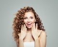 Surprised woman. Beautiful student girl with long curly hair. Presenting your product. Positive emotion. Royalty Free Stock Photo