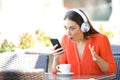 Surprised woman finding music offers on phone