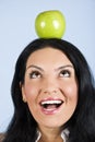 Surprised woman hold an apple on head Royalty Free Stock Photo