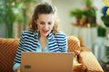 Surprised woman with laptop in modern house in sunny day Royalty Free Stock Photo