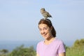 Surprised woman with a little owl on the head