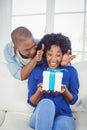 Surprised woman looking at gift on her hands Royalty Free Stock Photo