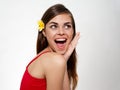 surprised woman with open mouth and yellow flower in her hair red t-shirt model Royalty Free Stock Photo