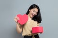 Surprised woman when opening heart shaped gift box Royalty Free Stock Photo