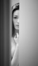 Surprised Woman Peeking Out of Bathroom Door Royalty Free Stock Photo