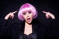 Surprised woman with pink wig on head. Emotion pink wigs woman. Fashion, cosmetics and makeup. Funny woung girl in wig