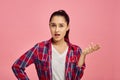 Surprised woman portrait, pink background, emotion