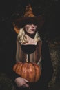 Surprised woman posing with knife and carved pumpkin. Halloween party art design. Happy Halloween. Witch. Happy Royalty Free Stock Photo