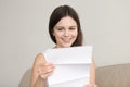 Surprised woman reading letter with unexpected good news, feelin Royalty Free Stock Photo