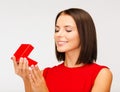 Surprised woman in red dress with gift box Royalty Free Stock Photo