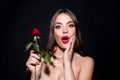 Surprised woman with red lips and rose flower. Fashion beauty portrait on studio background. Royalty Free Stock Photo