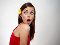 surprised woman in red t-shirt looks back and flower in her hair Royalty Free Stock Photo