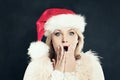 Surprised Woman in Santa Hat Having Fun. Christmas Sale Royalty Free Stock Photo