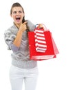 Surprised woman with shopping bags pointing on copy space Royalty Free Stock Photo