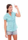 Surprised woman in short jeans pointing up Royalty Free Stock Photo