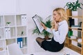 surprised woman sitting on table and looking Royalty Free Stock Photo