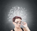 Surprised woman taking off glasses, question marks Royalty Free Stock Photo