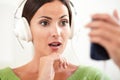 Surprised woman using a portable music player Royalty Free Stock Photo