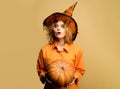 Surprised woman in witch hat with pumpkin. Girl in halloween costume with jack-o-lantern. Halloween holidays. Royalty Free Stock Photo