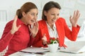 Surprised women architects working in modern office Royalty Free Stock Photo