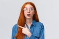 Surprised and wondered, amused attractive redhead woman in glasses, red natural hair, freckles, blue eyes open mouth