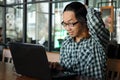 Surprised young Asian business man with laptop in office. Exhausted and overwork job concept. Royalty Free Stock Photo