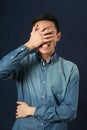 Surprised young Asian man covering his face by palm Royalty Free Stock Photo