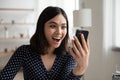 Surprised young asian vietnamese woman reading message with unexpected news. Royalty Free Stock Photo